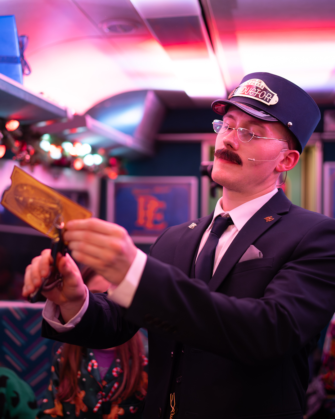 conductor clipping tickets on board the polar express london