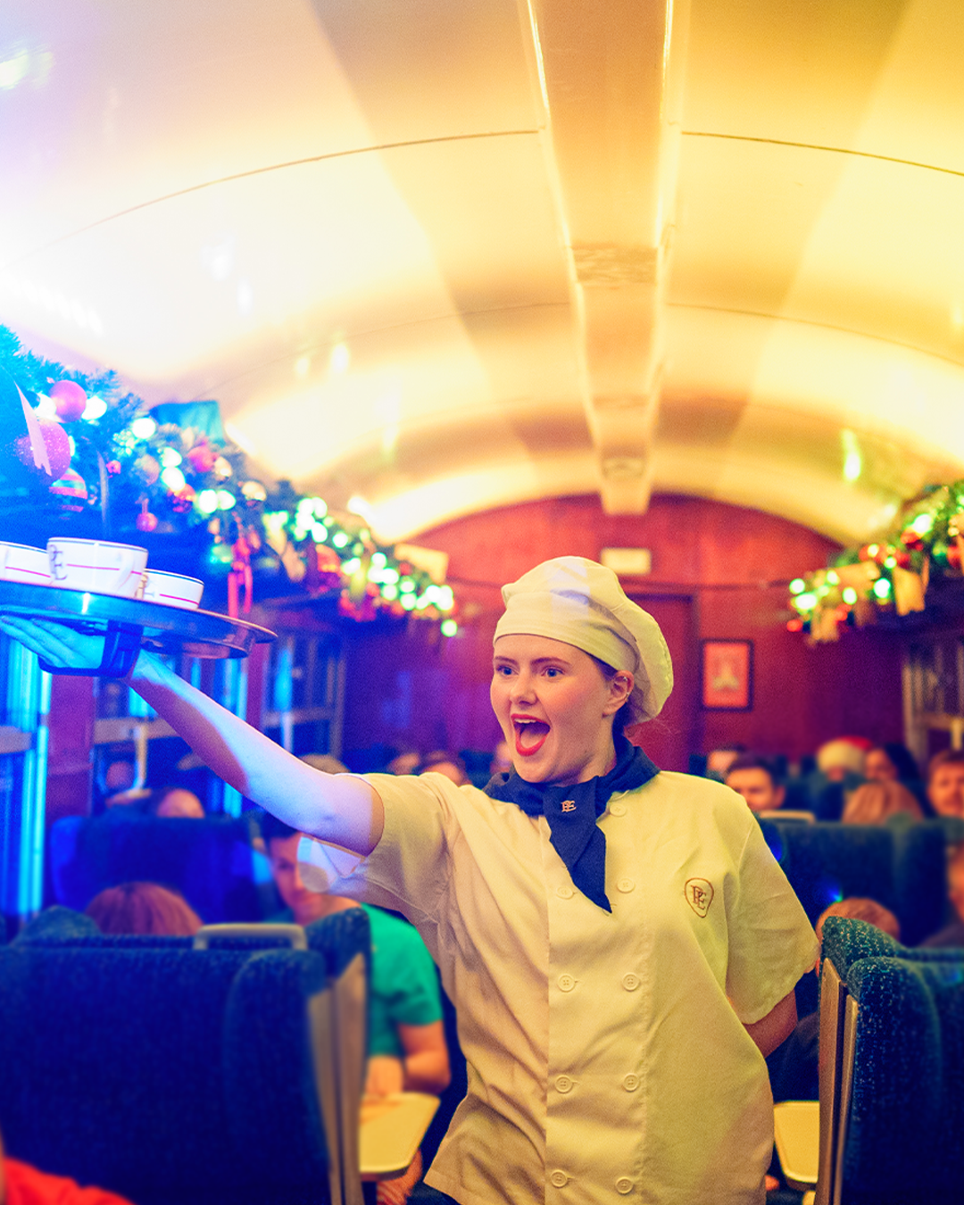 Chef with cups on board the polar express train ride